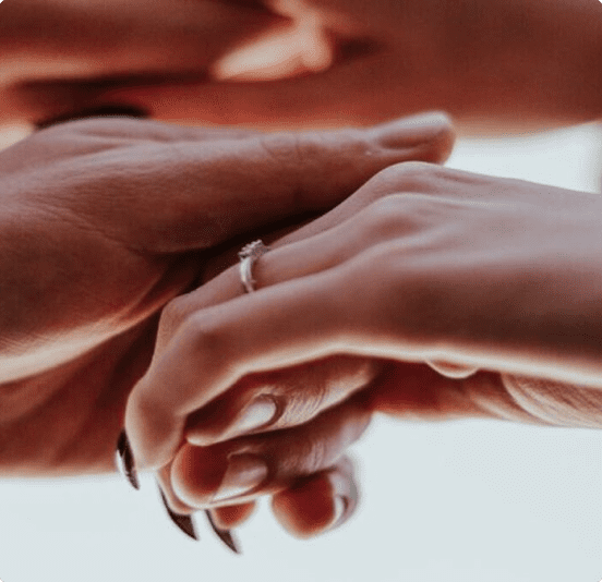 Two hands gently holding each other, symbolizing connection and affection.